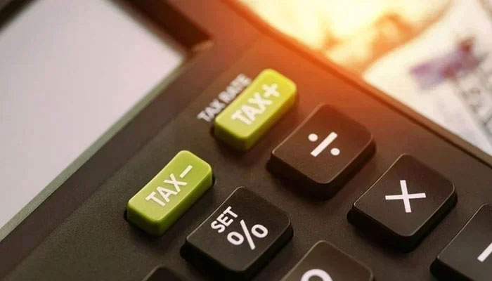 A representational image shows a tax written on a calculator. — AFP/File
