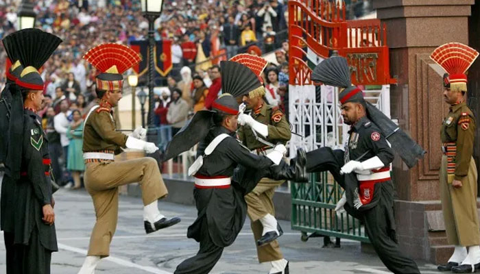 Pakistani and Indian security personnel during the flag lowering parade at Wagah border. — AFP/File
