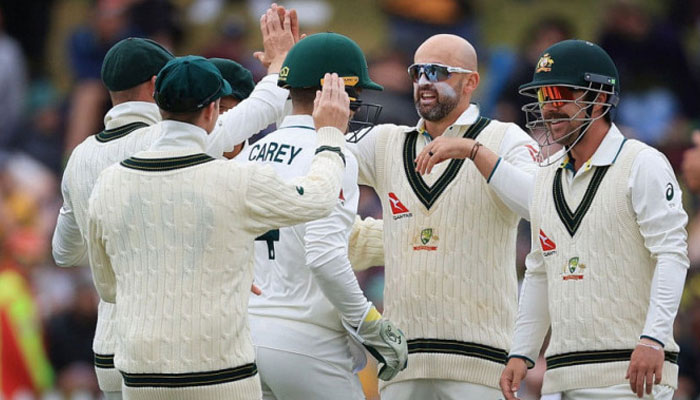 Australias Nathan Lyon celebrates with teammates during a match. — AFP/File