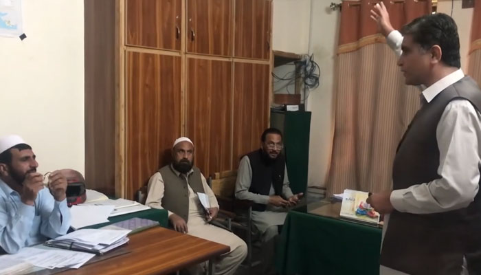 In this still, Tariq Chaman Awan Speaks to the employees of the district education department released on March 26, 2024. — Facebook/Kala Khatta Khoi Darra