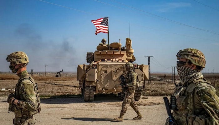 US soldiers walk while on patrol by the Suwaydiyah oil fields in Syrias northeastern Hasakah province. — AFP/File
