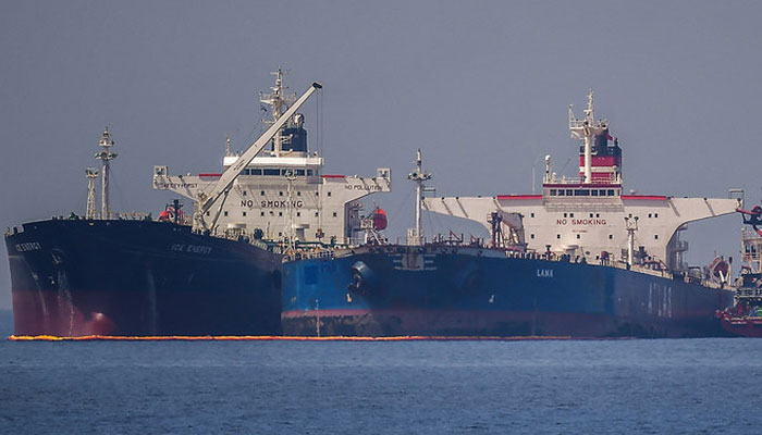 The Liberian-flagged oil tanker Ice Energy (L) transfers crude oil from the Russian-flagged oil tanker Lana (R) (former Pegas), off the shore of Karystos, on the Island of Evia, on May 29, 2022. — AFP