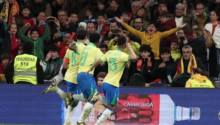 Brazil midfielder Lucas Paqueta (L) celebrates scoring his teams third goal in the draw against Spain. —  AFP/File