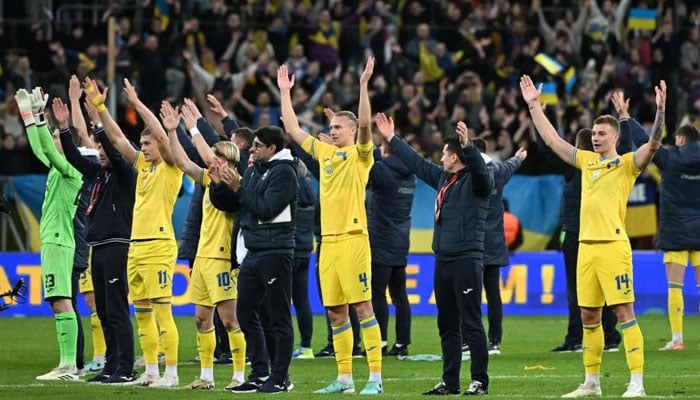 Ukraines players celebrate after the UEFAs EURO 2024 qualification final play-off football match between Ukraine and Iceland, in Wroclaw, Poland, on March 26, 2024. — AFP