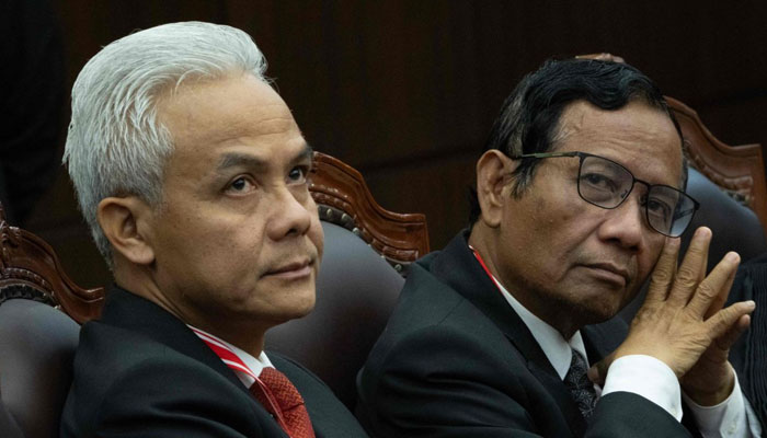 Indonesias presidential candidate Ganjar Pranowo (left) and vice president candidate Mahfud MD (right) attend the first hearing of their petition over the February 2024 elections. — AFP/File