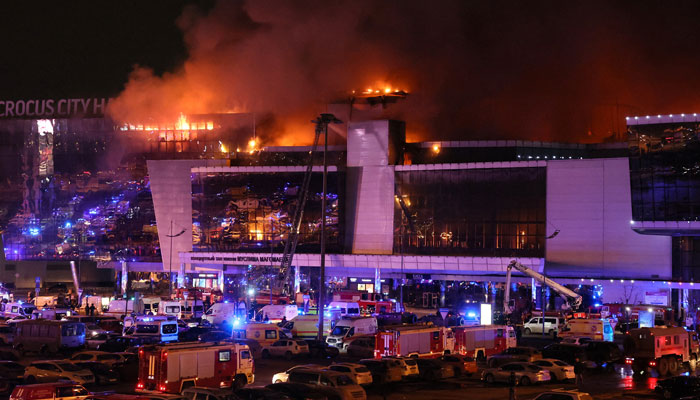 Emergency services vehicles are seen outside the burning Crocus City Hall concert hall in Krasnogorsk, outside Moscow, on March 22, 2024. — AFP