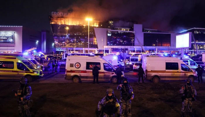 Law enforcement officers are seen deployed outside the burning Crocus City Hall concert hall following the shooting incident in Krasnogorsk, outside Moscow, on March 22, 2024. — AFP