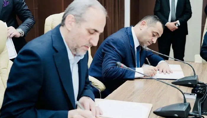 National Iranian Gas Company CEO Majid Chegeni (left) and Iraqs Ministry of Electricity Ziad Ali Fadhel signing a five-year barter deal in Baghdad on March 27, 2024. — Iran International