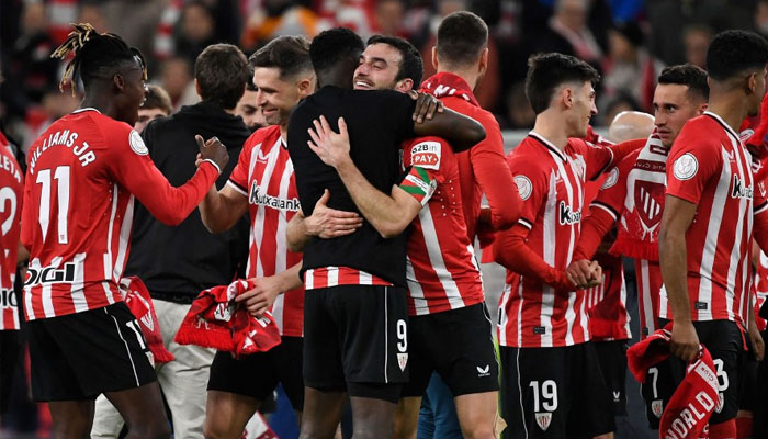 Athletic Bilbao players celebrate their victory at the end of the Spanish Copa del Rey (Kings Cup) semi final second leg football match between Athletic Club Bilbao and Club Atletico de Madrid at the San Mames stadium in Bilbao. — AFP