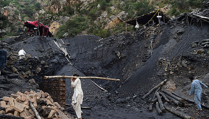 in this picture, Pakistani miners work in a coal mine. — AFP/File