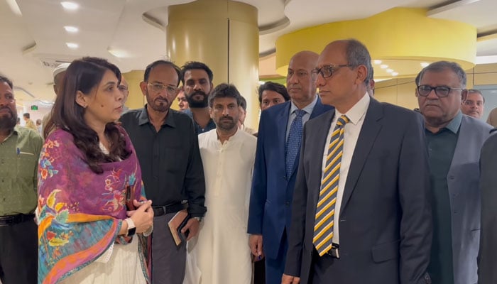 In this still, Sindh Local Government Minister Saeed Ghani speaks with officials during his visits to the Sindh Building Control Authority (SBCA) on March 28, 2024. — Facebook/Saeed Ghani