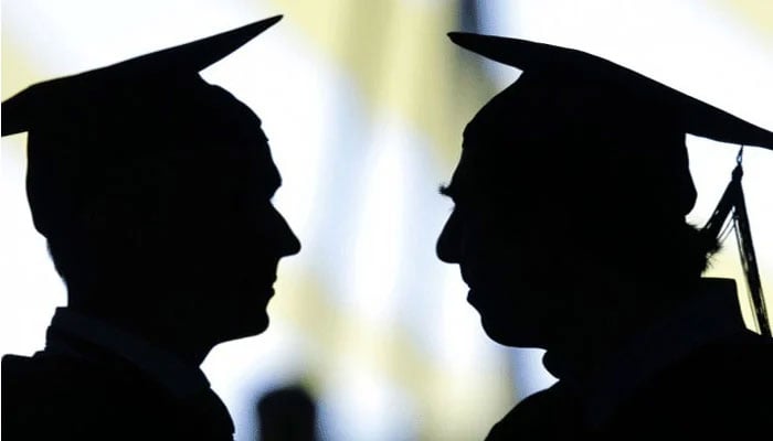 This representational image shows a shadow of two graduate students. — AFP/File