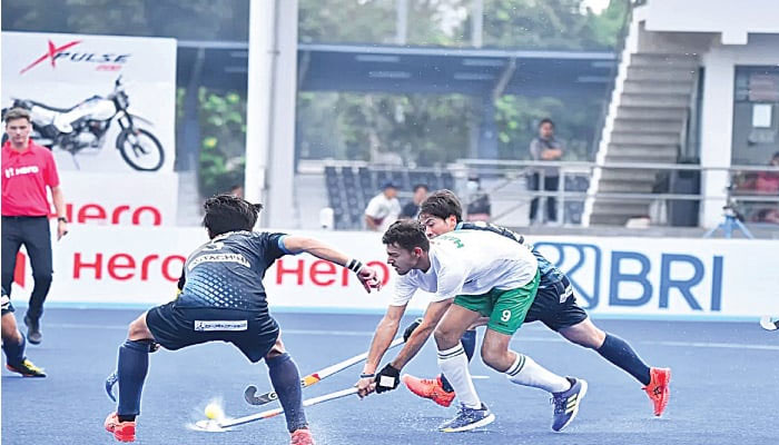 PAKISTAN’S Abdul Hanan (C) vies for the ball with Japan players during their Asia Cup match at the GBK Sports Arena on Thursday. — AHF