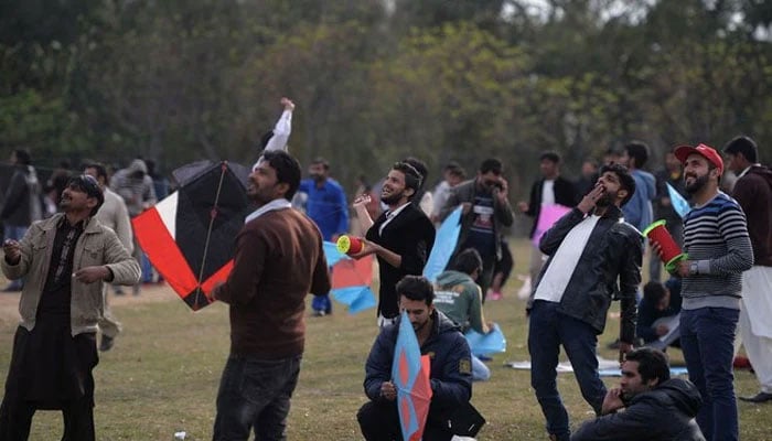 Pakistani kite flyers fly kites at a park. — AFP/ File