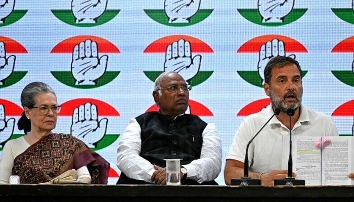 India’s Congress party president Mallikarjun Kharge (C) with party leaders Sonia Gandhi (L) and Rahul Gandhi (R) address a press conference at the Congress party headquarters in New Delhi, India on March 21. — AFP
