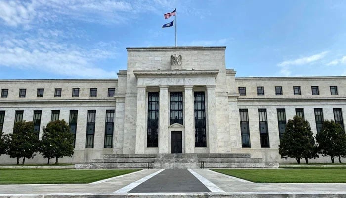The USA and Federal Reserve flags fly on top of the Federal Reserve Board building in Washington DC, USA on July 1, 2020. — AFP