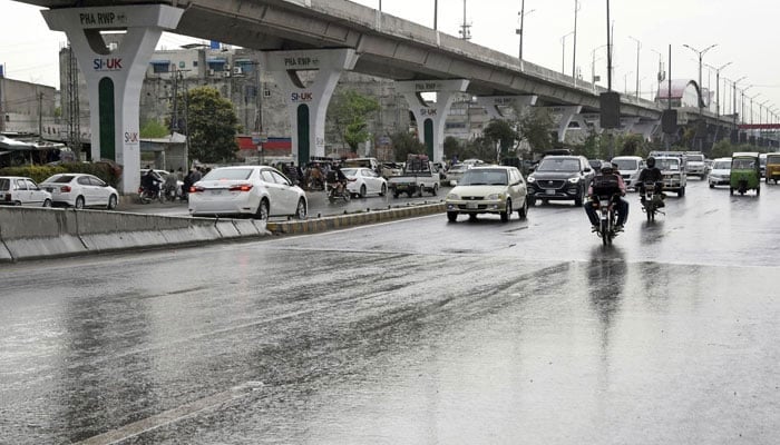 This representational image shows motorists on their way during heavy rain. — Online/File