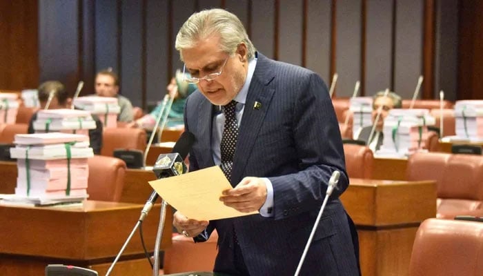 Foreign Minister (then Finance Minister) Ishaq Dar reads a copy of the Finance Bill, 2023-2024 in Senate on June 9, 2023. — Senate of Pakistan website/File