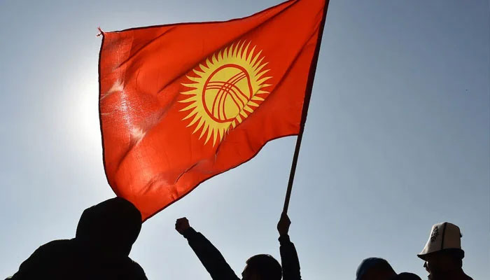 A citizen waves a Kyrgyz flag during a rally in Bishkek. — AFP/File