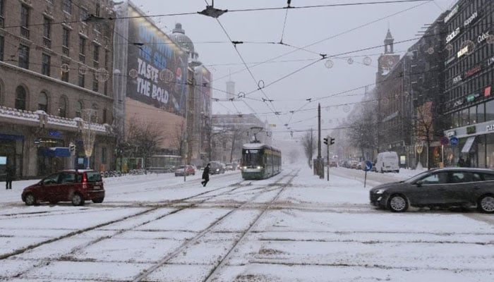 Cars and a tramway drive in Mannerheimintie street in Helsinki. — AFP/File