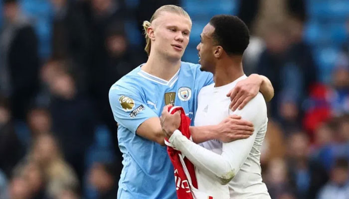 Manchester Citys Erling Haaland (L) and Arsenals Brazillan defender Gabriel Magalhaes interact at the end of the English Premier League football match at the Etihad Stadium in Manchester, England on March 31, 2024. — AFP