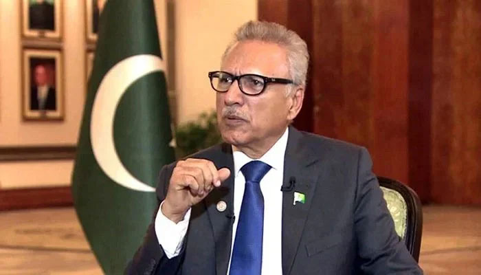 Former President of Pakistan Arif Alvi gestures during an interview. — PID/File