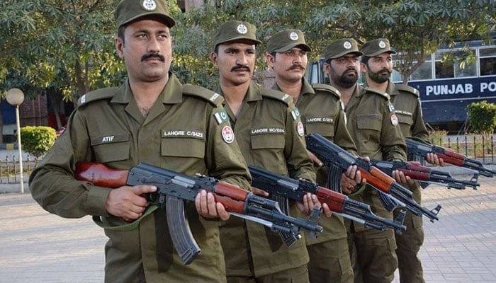 Personnel of the Punjab police pose for a photo. — APP File
