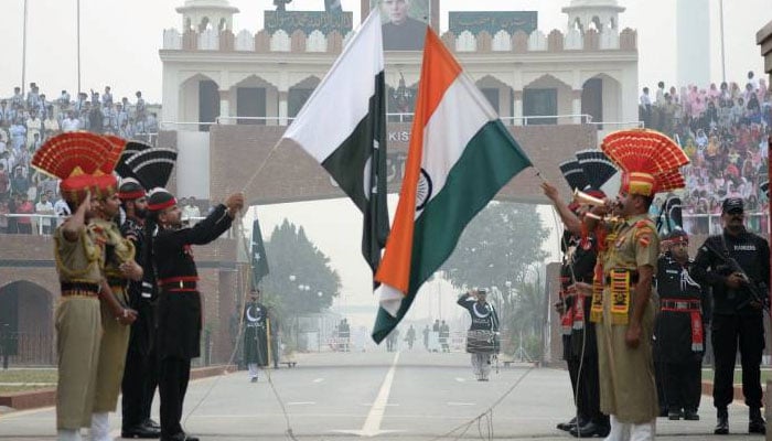 Pakistani and Indian soldiers take part in the flag lowering ceremony at the Pak-India Wagah Border. — AFP/File