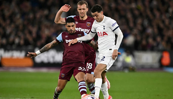 West Ham Uniteds Italian defender Emerson, West Ham Uniteds Czech midfielder Tomas Soucek and Tottenham Hotspurs Welsh striker Brennan Johnson during the English Premier League football match between West Ham United and Tottenham Hotspur at the London Stadium, in London on April 2, 2024. — AFP