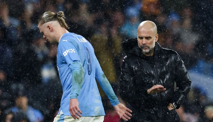 Manchester Citys Spanish manager Pep Guardiola (right) and Manchester Citys Norwegian striker Erling Haaland. — AFP