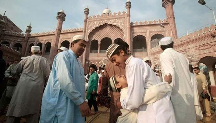 A representational image showing people embrace each other on the festive occasion of Eid. — AFP/File