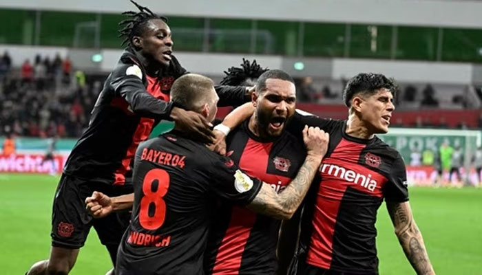 Bayer Leverkusens German defender Jonathan Tah (2nd R) celebrates scoring the 3-2 winning goal with his team-mates during the German Cup (DFB Pokal) quarter-final. — AFP
