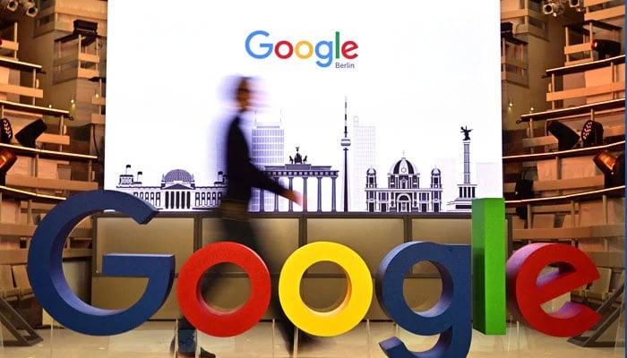 This file photo taken on January 22, 2019 shows a technician passing by a logo of US internet search giant Google during the opening day of a new Berlin office of Google in Berlin. — AFP/File