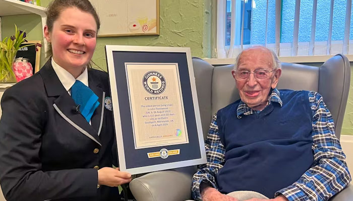 John Tinniswood, 111, poses with his certificate from the Guinness World Records, who announced that he is the worlds oldest living man, in Southport, Britain April 4, 2024 in this handout image. — Guinness World Records