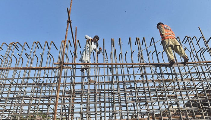 Pakistani labourers work on an under construction site in Lahore.  — AFP/File