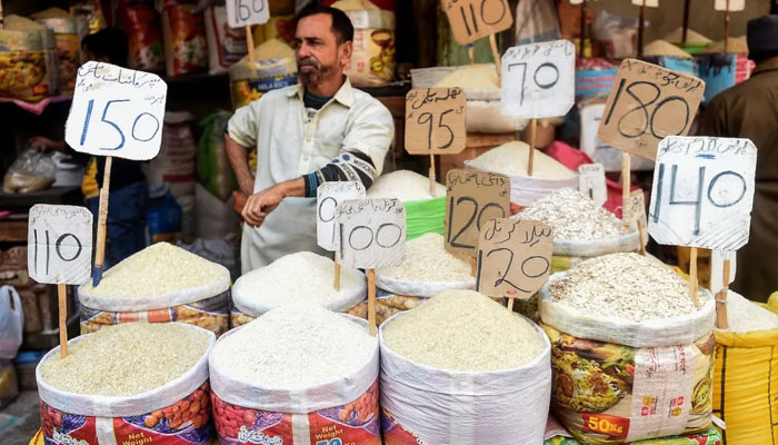 A shopkeeper pictured at a grocery shop in a market in Karachi. — AFP/File