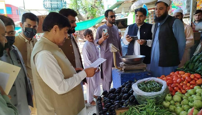 Khyber Pakh­tunkhwa Minister for Food Zahir Shah Toru reviewing the price list during the surprise visits to Nowsheras market, this image was released on April 6, 2024. — Facebook/Zahir Shah Toru