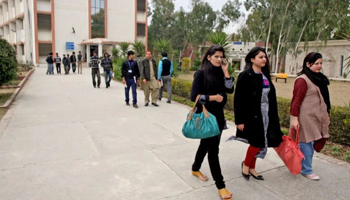 A representational image showing university students walking inside a varsity. — AFP/File
