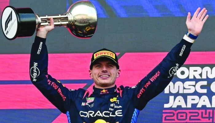 World champion Max Verstappen poses with the trophy after winning the at the Japanese Formula One Grand Prix on April 7, 2024. — AFP