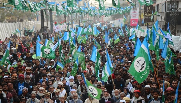 Supporters of the Jamaat-e-Islami protest hold flags at a rally in Karachi. — Online/File