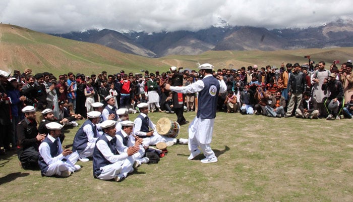 A person dances as others look on during Qaqlasht festival. — Facebook/PAMIR TIMES/File