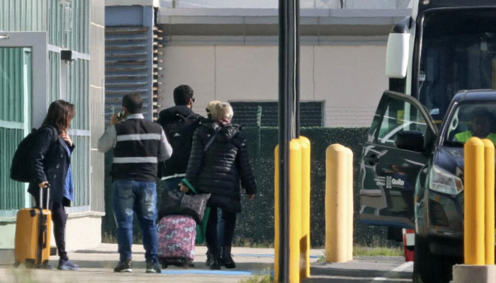 This Picture showing Mexicos Ambassador to Ecuador, Raquel Serur Smeke (R), leaving the country at Mariscal Sucre International Airport in Quito on April 7, 2024. — AFP