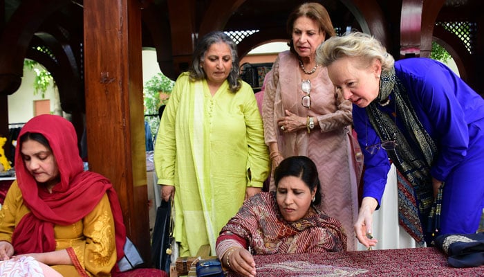 Ambassador of Austria to Pakistan Andrea Wicke looking at handmade work on a stall during Eid Bazaar, at a local hotel in Islamabad on April 7, 2024. — Online