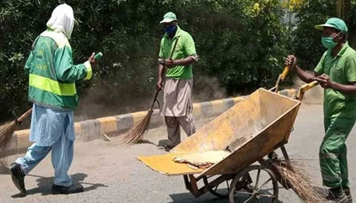Local governments and waste management companies workers clean the road. — APP/File