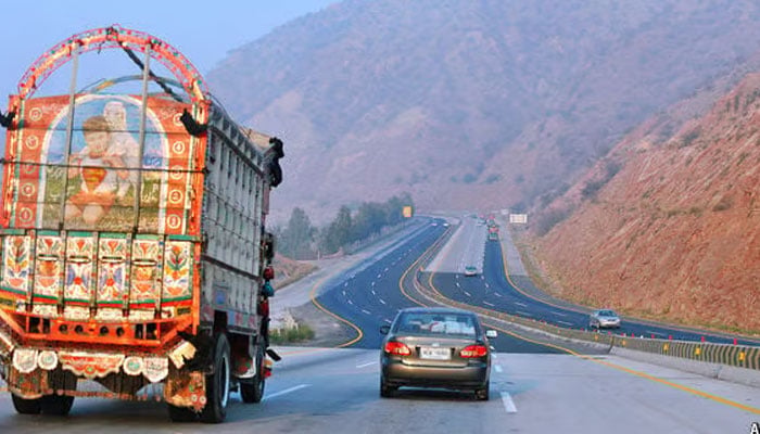 A representational image showing a car and a truck travelling on a section of a motorway. — AFP/File