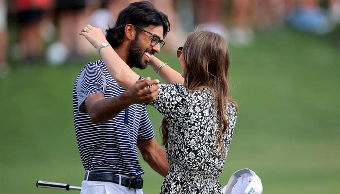 Akshay Bhatia is greeted by his wife, Presleigh Schultz, after winning on the first playoff hole during the final round of the Valero Texas Open golf tournament on April 7, 2024.— USA Today