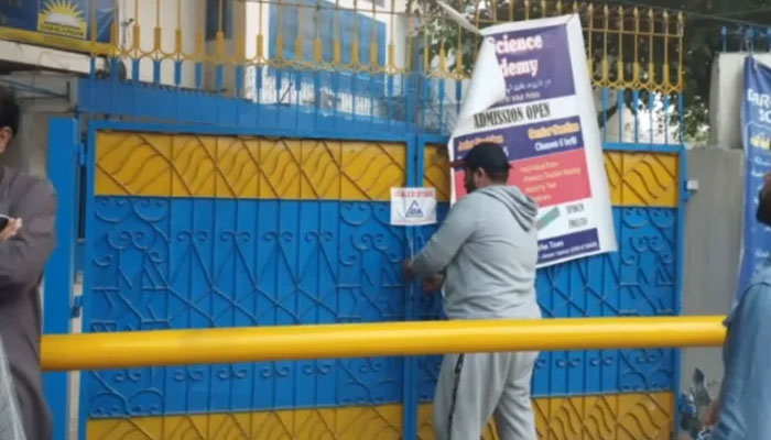 This still taken from a video released on October 30, 2023, shows an LDA official sealing a commercial premises. — Facebook/Lahore Development Authority