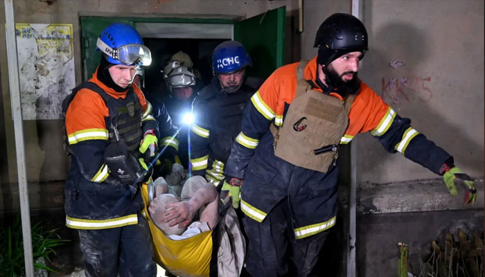 Rescuers carry an injured man on a stretcher following a Russian strike in Kharkiv. — AFP/File