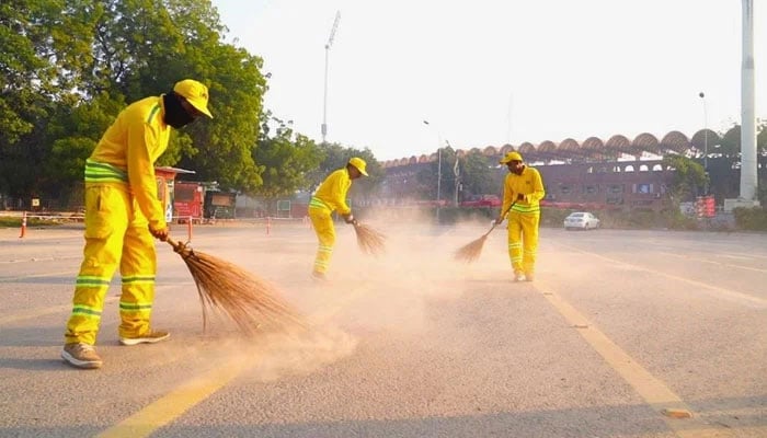 Lahore Waste Management Company (LWMC) workers cleaning the streets. — APP/File