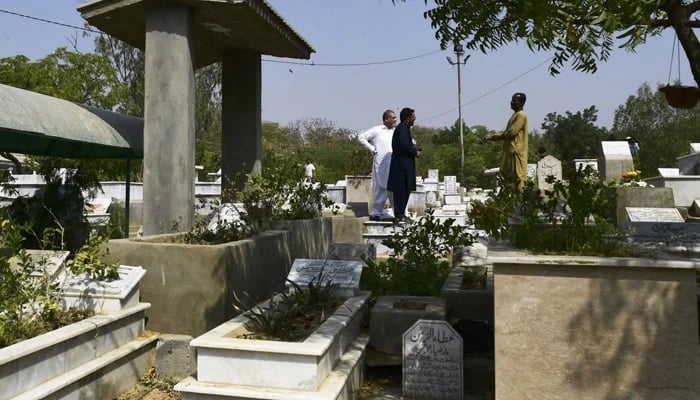 A representational image shows people in a cemetery. — AFP/File